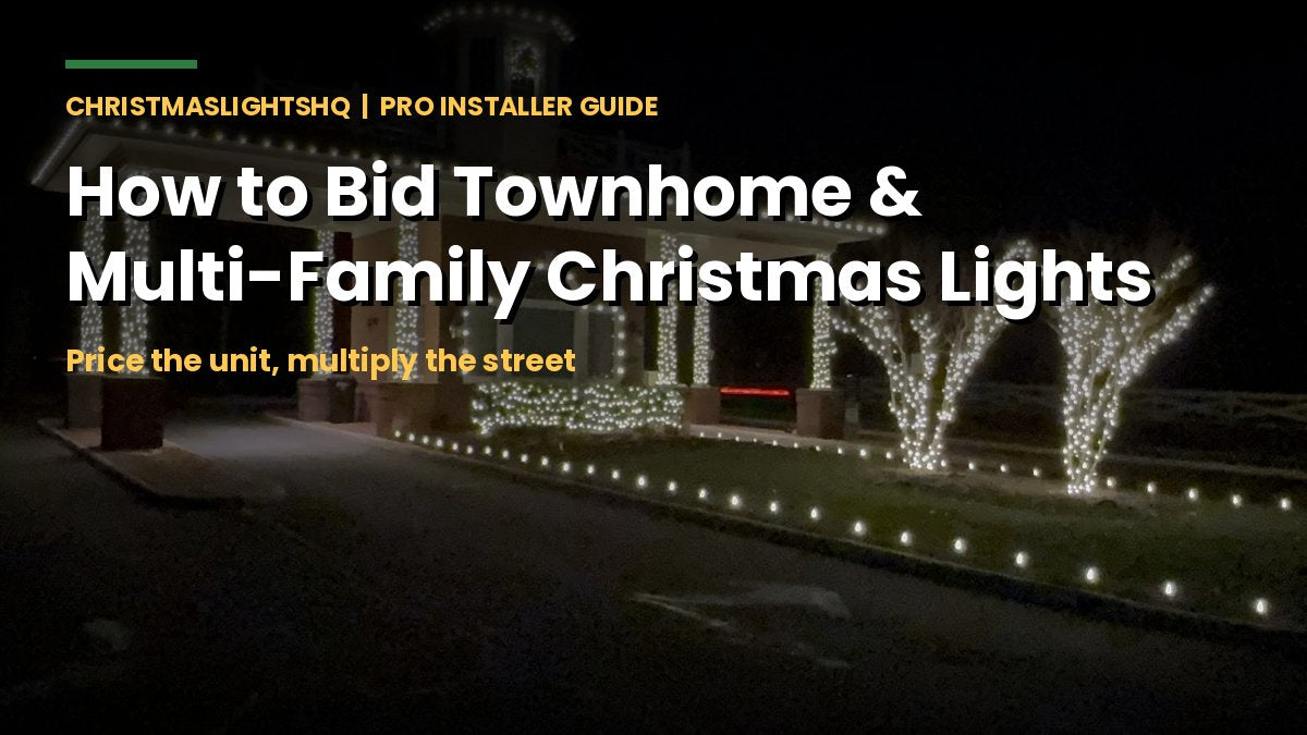 Lit community entrance with wrapped trees and columns - bidding townhome and multi-family Christmas light jobs